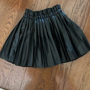 Size 130 pleather pleated skirt worn twice . Excellent condition